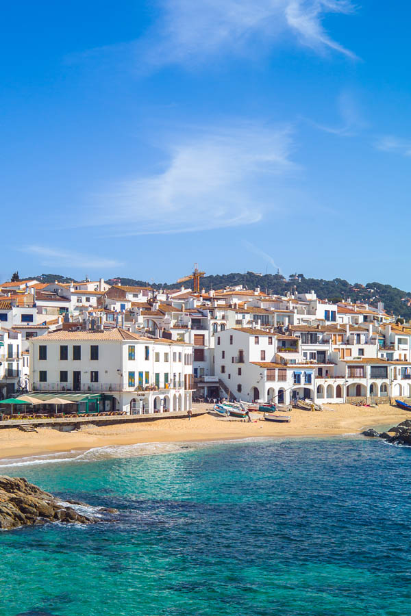 A beautiful beach with white buildings for my spain winter packing list article