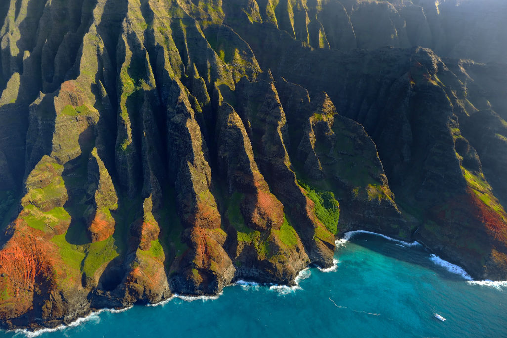 Jagged cliffs around the shoreline on my Kauai winter packing list post