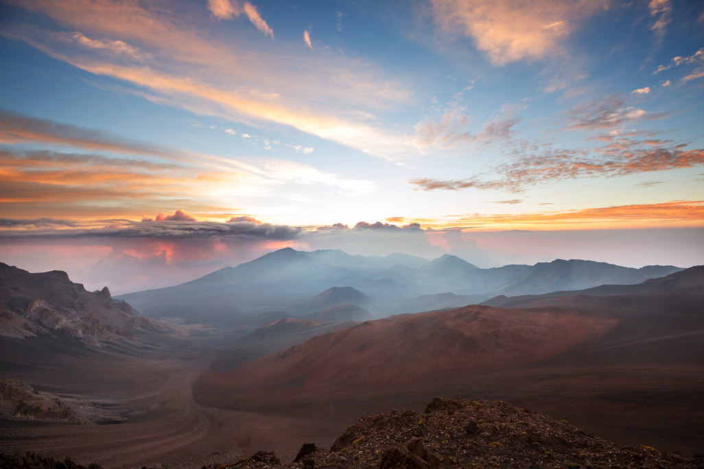 sunrise over red dusty mountains on my maui winter packing list post