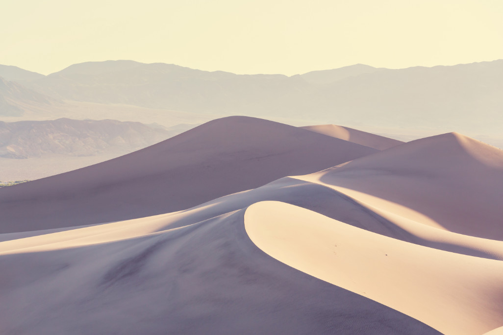 a sandy desert at sunrise on my california winter packing list post